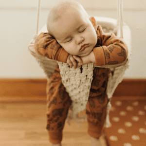 Sleeping baby in macrame swing