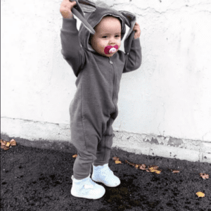 Toddler wearing grey bunny playsuit with floppy ears