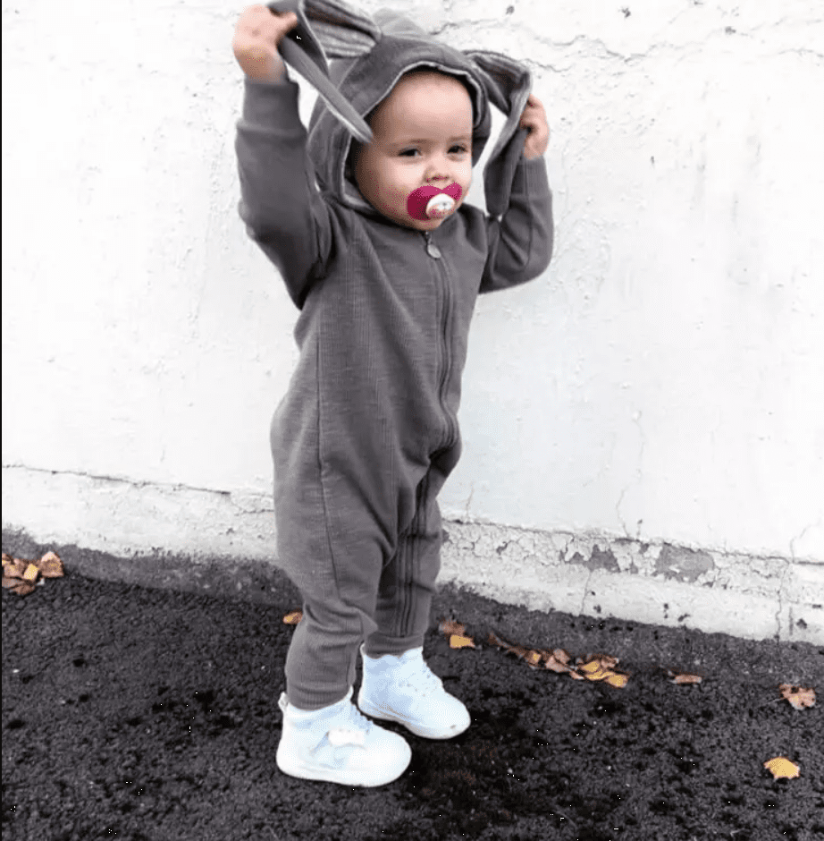 Toddler wearing grey bunny playsuit with floppy ears
