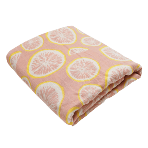 Pink baby swaddle blanket with pink and yellow grapefruit slices pattern