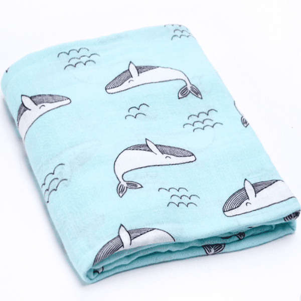 Blue baby swaddle blanket with whales pattern